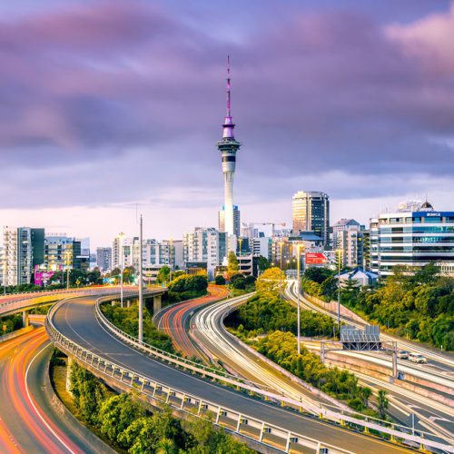 Long exposure of urban roads with traffic leading to Auckland city at dusk, North Island, New Zealand